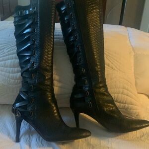 Black lace up boots with inside zipper. Stiletto heel.